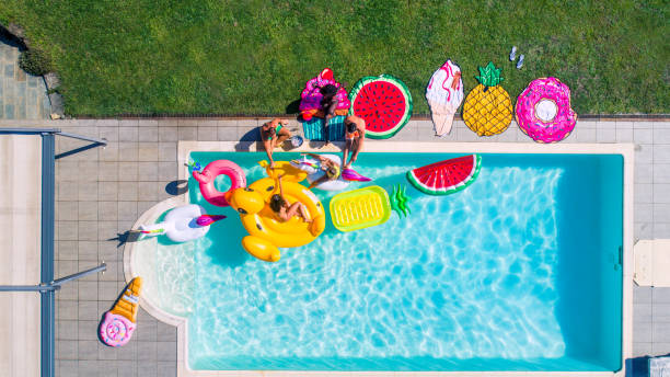 istock Friends having fun in a swimming pool 1222180396