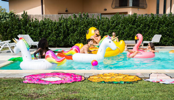 istock Friends having fun in a swimming pool 1222181898