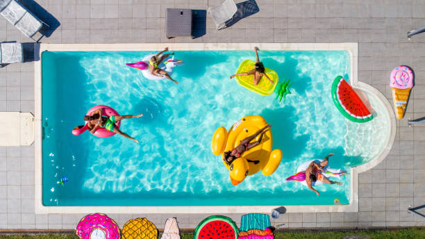 istock Friends having fun in a swimming pool 1222182394