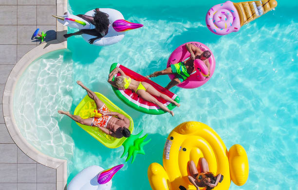 istock Friends having fun in a swimming pool 1222183376