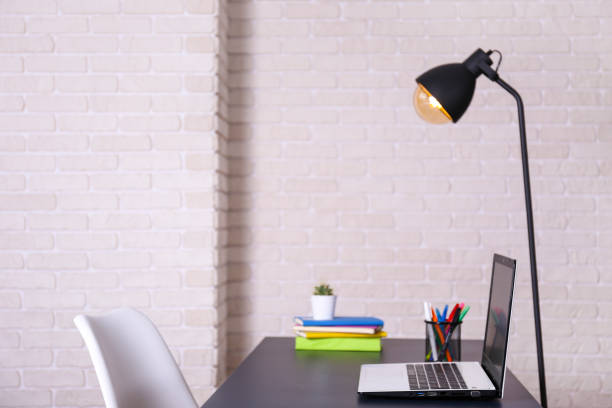 istock Workplace in corner office with laptop and bunch of accessories. 1222183497
