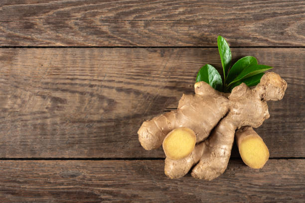Fresh ginger on wooden background, top view stock photo