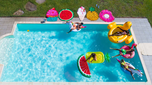 istock Friends having fun in a swimming pool 1222184326