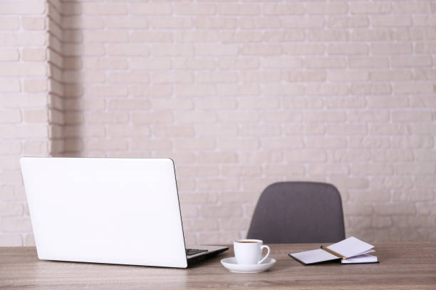 istock Workplace in corner office with laptop and bunch of accessories. 1222184377