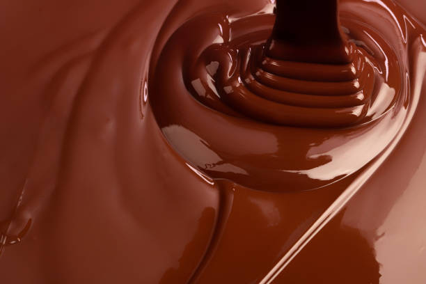 istock hot swirl chocolate background, splash liquid cocoa 1222185118