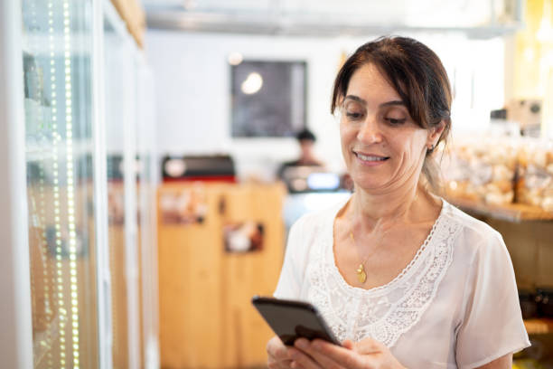 istock Senior woman customer buying using mobile phone at store 1222185120