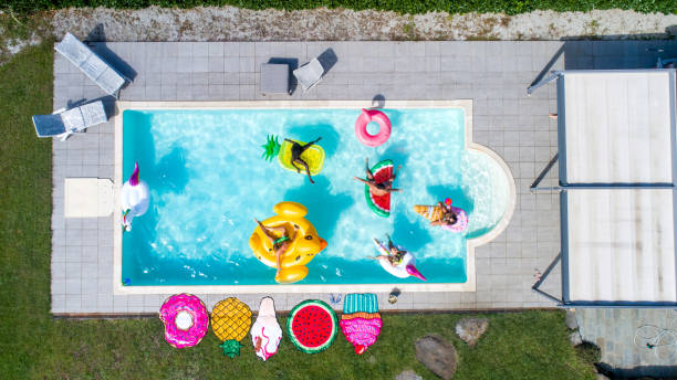 istock Friends having fun in a swimming pool 1222185168