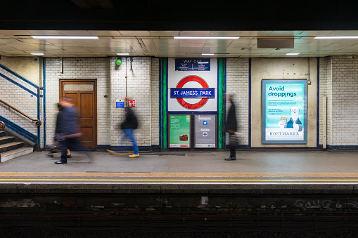 London, United Kingdom - February 02, 2019: Victoria line tube train waiting at Vauxhall station, door open -  passengers walking on the platform