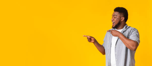 istock Cool Offer. Cheerful Black Guy Pointing Aside At Copy Space 1222185868