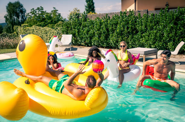 istock Friends having fun in a swimming pool 1222186746