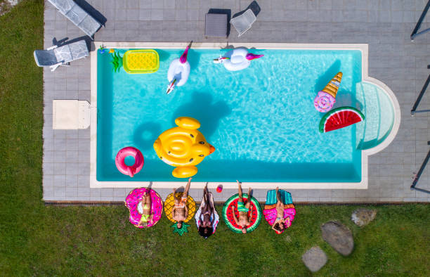 istock Friends having fun in a swimming pool 1222187419