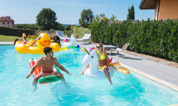 istock Friends having fun in a swimming pool 1222187630