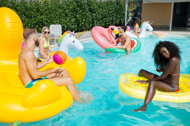 istock Friends having fun in a swimming pool 1222187886