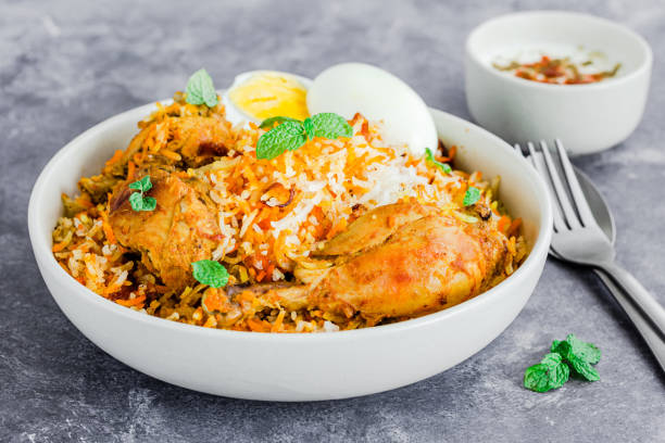 istock Chicken Biryani with Raita and Eggs on Dark Background Horizontal Photo 1222187924