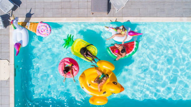 istock Friends having fun in a swimming pool 1222188196