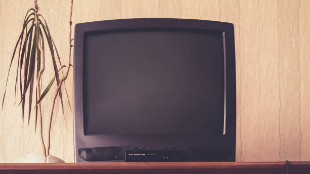 istock old black TV set stands on vintage wooden commode with patterns at small plant 1222189160
