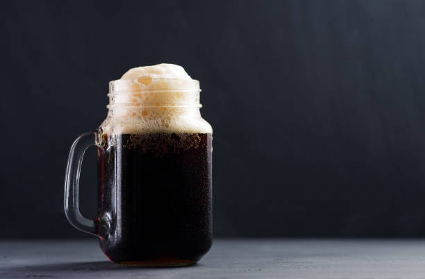 istock A glass Can of dark beer with a handle on a concrete table 1222189231