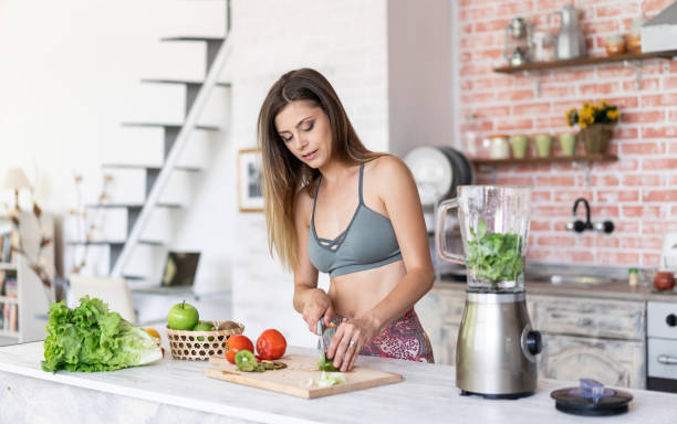istock Woman making a healthy salad at home during isolation 1222189416