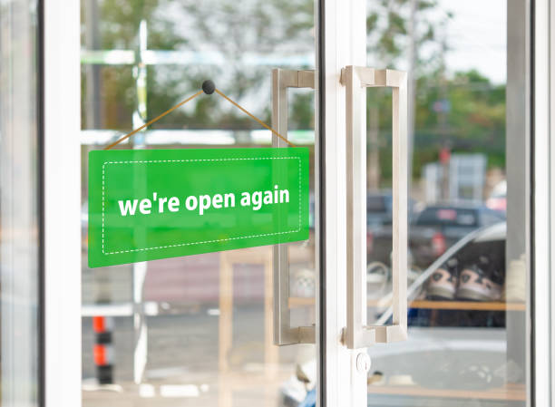 The green label has the message that "we're open again" on the entrance door. The green label has the message that "we're open again" on the entrance door. again stock pictures, royalty-free photos & images