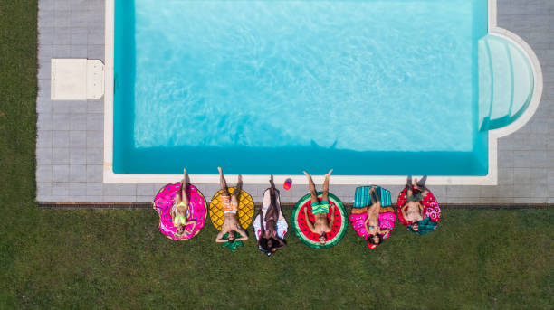 istock Friends having fun in a swimming pool 1222190544