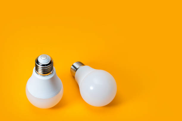 istock LED, New technology light bulb on yellow background, Energy super saving electric lamp is good for environment 1222190930
