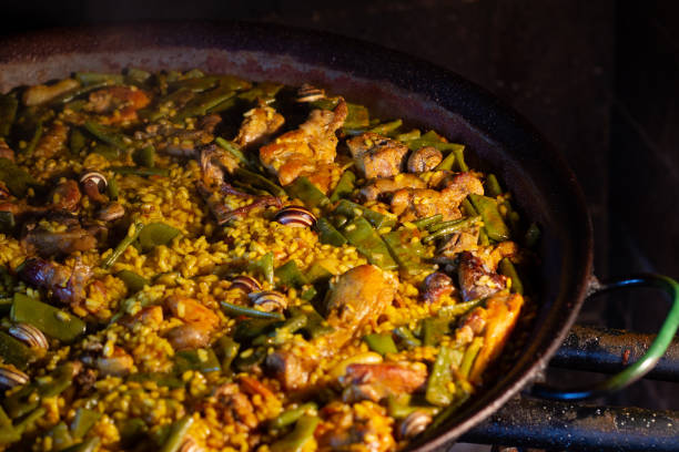 istock Typical Valencian paella cooked traditionally in a gas fire, whose main ingredients are rice, chicken, rabbit, green beans and snails. 1222191685