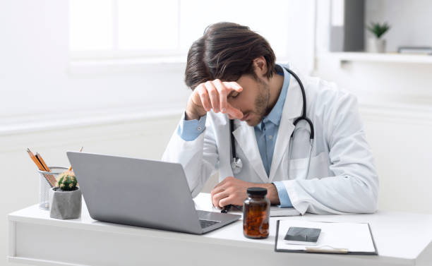 istock Exhausted doctor napping at workplace, need break in hard pandemic work 1222191911