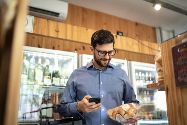 istock Mid adult man customer buying using mobile phone at store 1222194004
