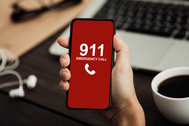 istock Worker holding smart phone with emergency number 1222194006