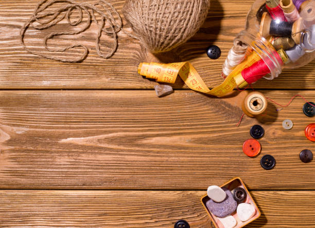 istock Sewing accessories such as threads and needles on a wooden table. Copy space. homework concept 1222194647