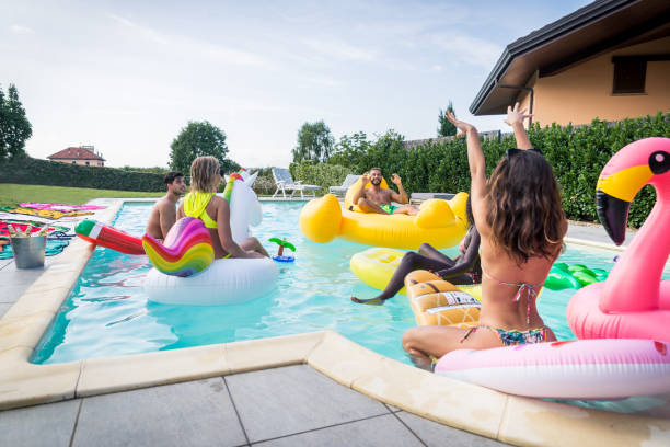istock Friends having fun in a swimming pool 1222195696
