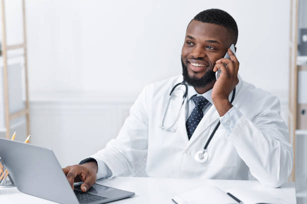 istock Friendly doctor asking about patients health, using mobile phone 1222195932
