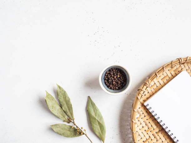 istock Kitchen notepad mock up for culinary text on wicker tray and spices on light background. Minimalism kitchen concept. Top view. Copy space 1222196079