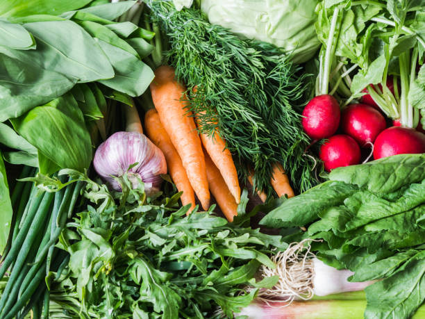 istock Fresh Spring vegetables and herbs - carrots, ramson, radish, dill, garlic, arugula, green onions background. Food healthy background. 1222196122