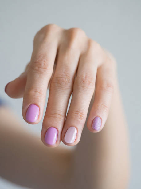 istock A woman's hand with a pastel manicure, close-up 1222196829