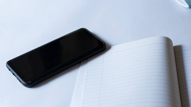 istock Phones and books are placed on the white table 1222196972