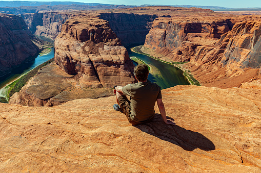 A man enjoys the view of the Beautiful Colorado Horseshoe Bend, Colorado River, Grand Canyon, Arizona, USA,Nikon D3x