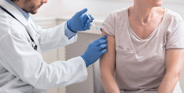 istock Senior woman getting vaccination injection from doctor 1222197618
