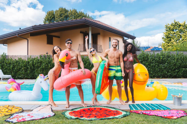 istock Friends having fun in a swimming pool 1222198221