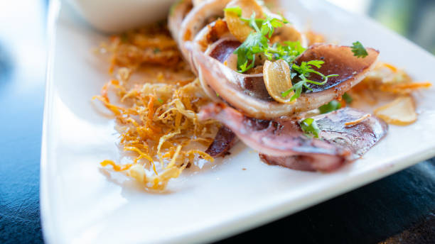 istock grilled squid with seafood sauce on plate. 1222198396