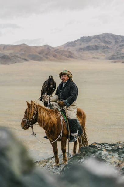 istock Eagle hunter on horse in desert in Mongolia 1222198484