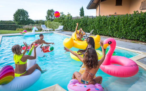 istock Friends having fun in a swimming pool 1222200134