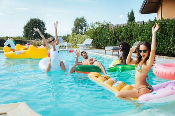 istock Friends having fun in a swimming pool 1222200540