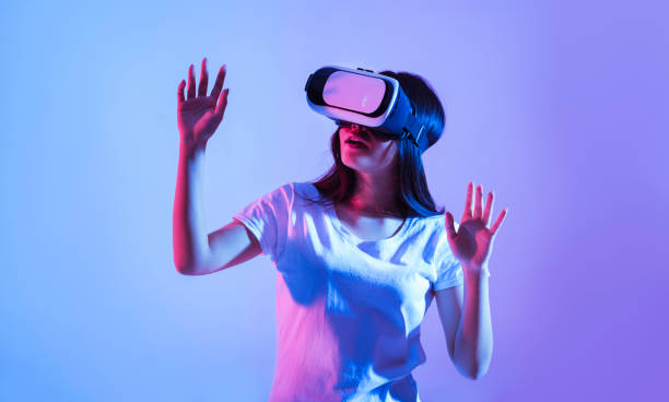 istock Girl in virtual reality glasses in neon 1222200656