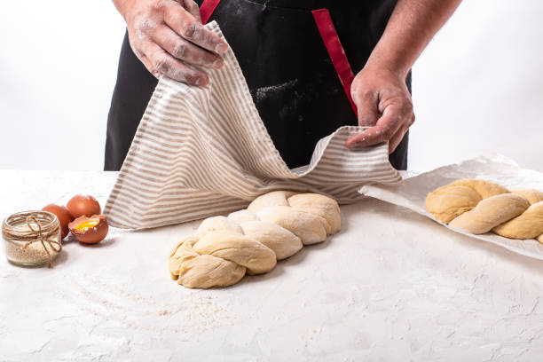 The concept of oriental cuisine. National Israel homemade Raw challah traditional jewish bread covered with linen towel The concept of oriental cuisine. National Israel homemade Raw challah traditional jewish bread covered with linen towel. judiaca stock pictures, royalty-free photos & images