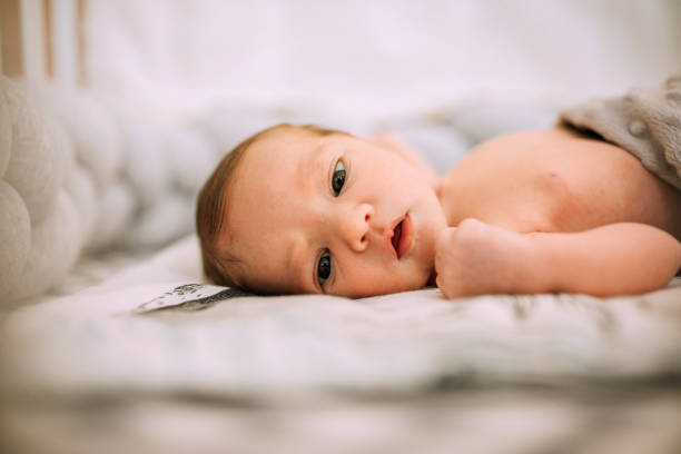 istock Cute Baby Boy Lying In The Crib 1222201893