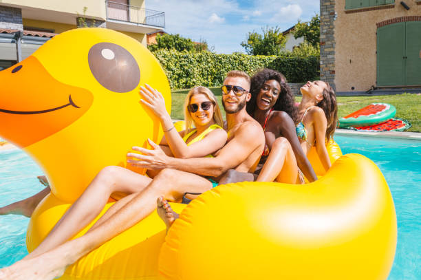 istock Friends having fun in a swimming pool 1222202022