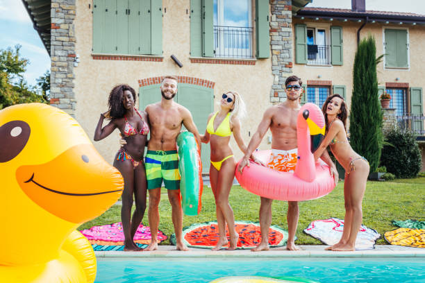 istock Friends having fun in a swimming pool 1222202783
