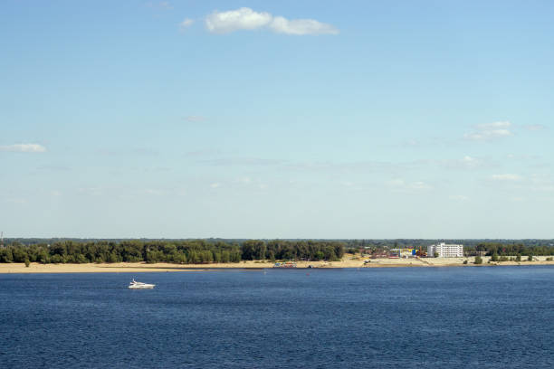 small white boat sailing the river. summer background, Volga river, Volgograd
