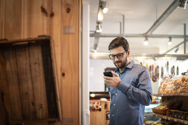 istock Mid adult man customer buying using mobile phone at store 1222204553